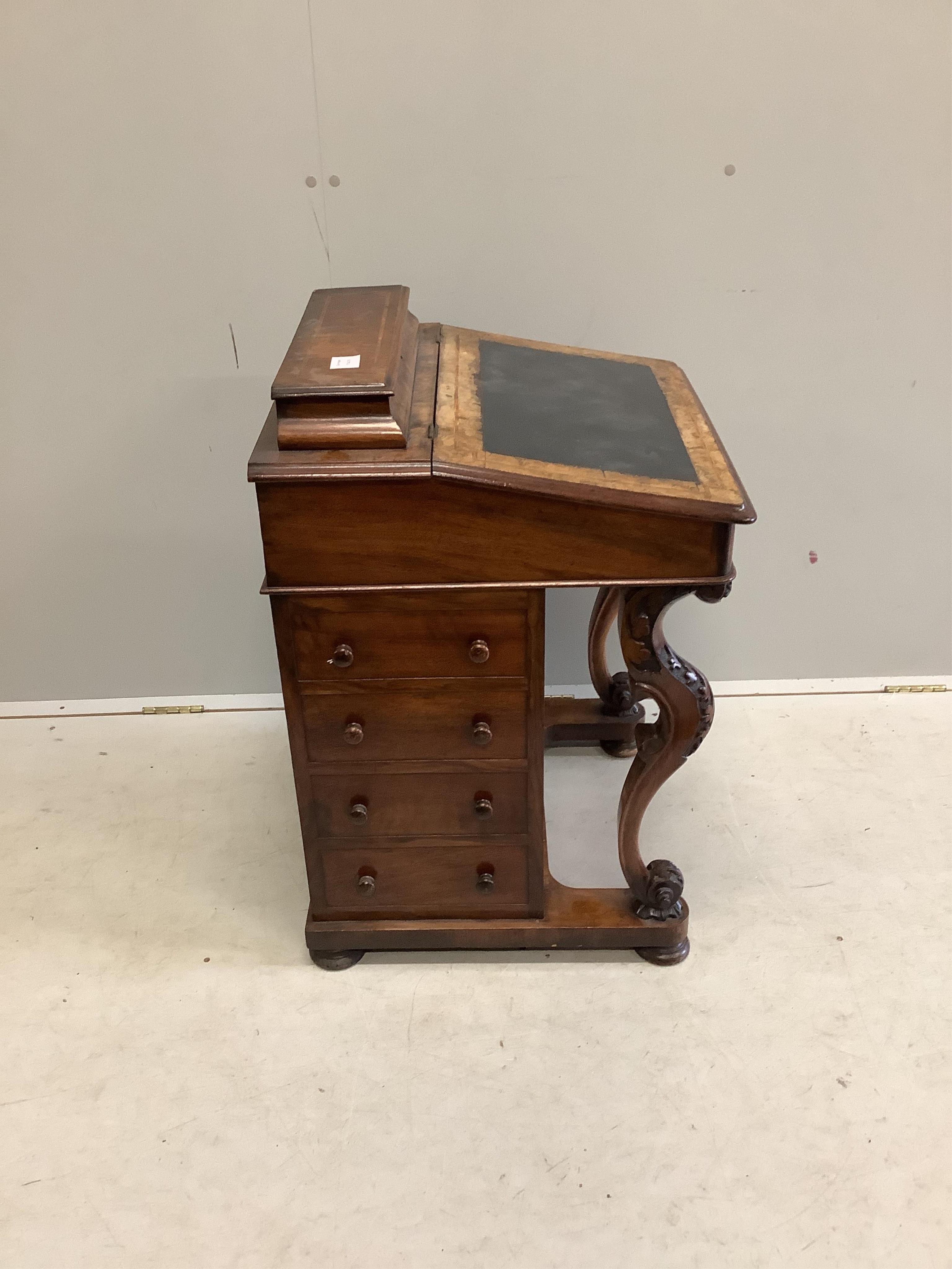 A late Victorian banded figured walnut Davenport, width 54cm, depth 54cm, height 78cm. Condition - fair